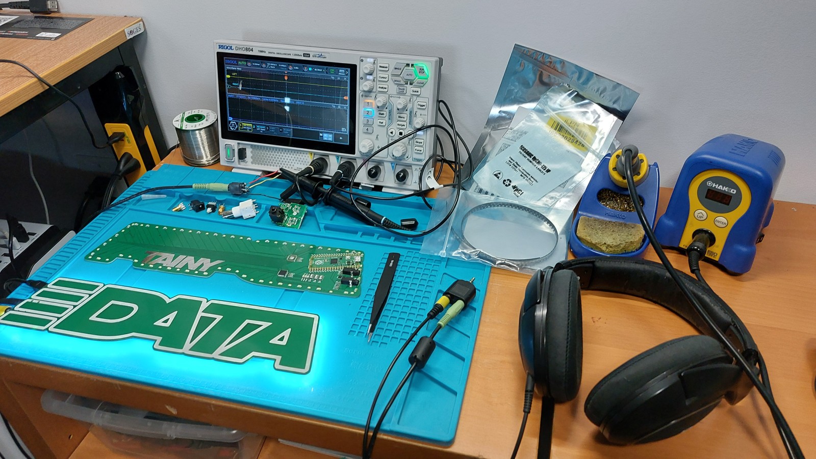 Testing setup with oscilloscope probing the audio passed through, headphones split off at the source aux port