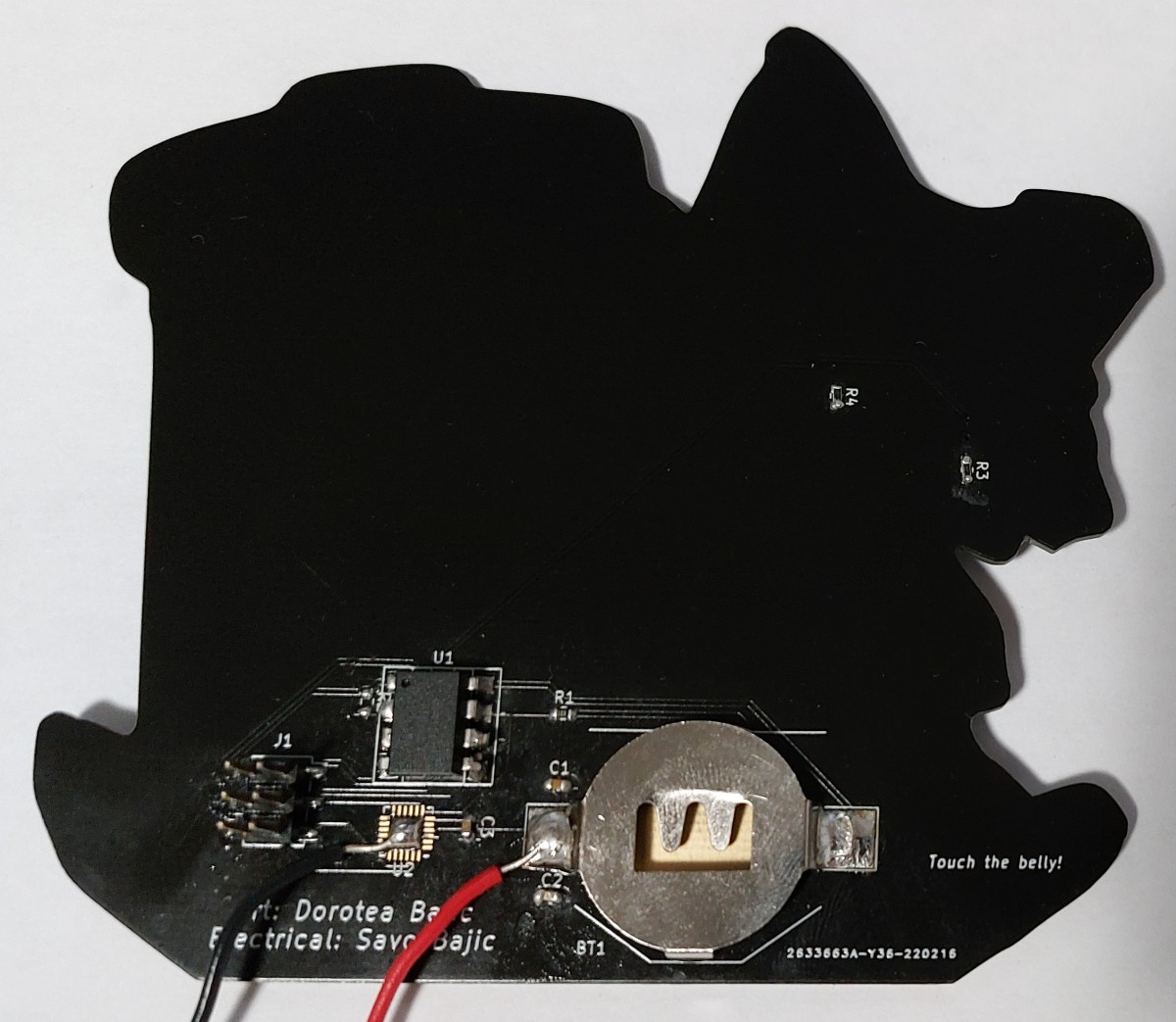 The assembled circuitry on the rear of the raccoon. Note: the wires were used for power delivery during programming.